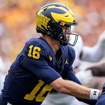 Michigan quarterback Davis Warren (16) hands the ball to running back Donovan Edwards (7) against Texas during the second half at Michigan Stadium in Ann Arbor on Saturday, September 7, 2024.