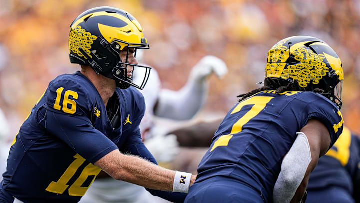 Michigan quarterback Davis Warren (16) hands the ball to running back Donovan Edwards (7) against Texas during the second half at Michigan Stadium in Ann Arbor on Saturday, September 7, 2024.