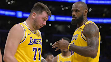 Feb 10, 2025; Los Angeles, California, USA; Los Angeles Lakers forward LeBron James (23) checks on guard Luka Doncic (77) after he was hit in the face against the Utah Jazz at Crypto.com Arena. Mandatory Credit: Jayne Kamin-Oncea-Imagn Images