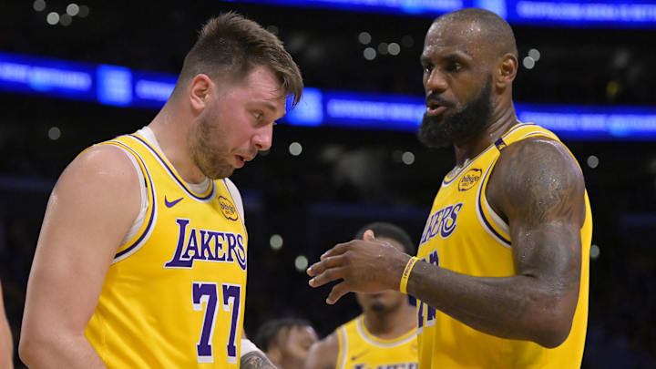 Feb 10, 2025; Los Angeles, California, USA; Los Angeles Lakers forward LeBron James (23) checks on guard Luka Doncic (77) after he was hit in the face against the Utah Jazz at Crypto.com Arena. Mandatory Credit: Jayne Kamin-Oncea-Imagn Images