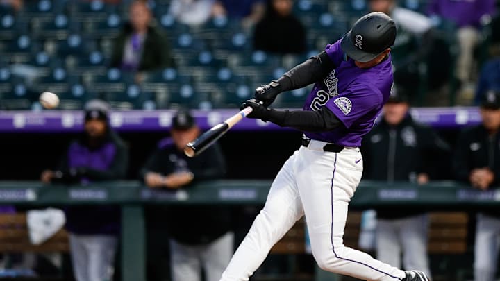Apr 28, 2025; Denver, Colorado, USA; Colorado Rockies right fielder Mickey Moniak (22) hits a single in the fourth inning against the Atlanta Braves at Coors Field. Mandatory Credit: Isaiah J. Downing-Imagn Images