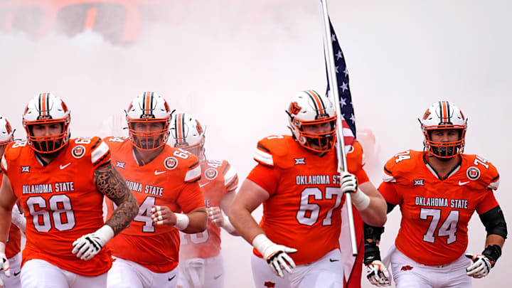 Oklahoma State runs on to the field before the college football game between the Oklahoma State Cowboys and South Dakota State Jackrabbits at Boone Pickens Stadium in Stillwater, Okla.