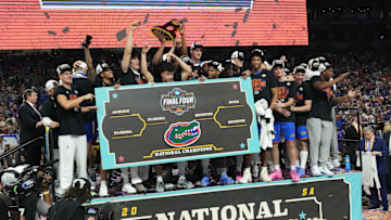 Apr 7, 2025; San Antonio, TX, USA;  Florida Gators players celebrate with the trophy after defeating the Houston Cougars in the national championship game of the Final Four of the 2025 NCAA Tournament at the Alamodome. Mandatory Credit: Robert Deutsch-Imagn Images