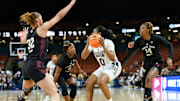 Mississippi State guard Darrione Rogers (0) keeps the ball from Texas A & M defense Lauren Ware (32), Kay Kay Green (4) and Maliyah Johnson (14) during the first quarter of the SEC Women's Basketball Tournament game three at the Bon Secours Wellness Arena in Greenville, S.C. Thursday, March 7, 2024.