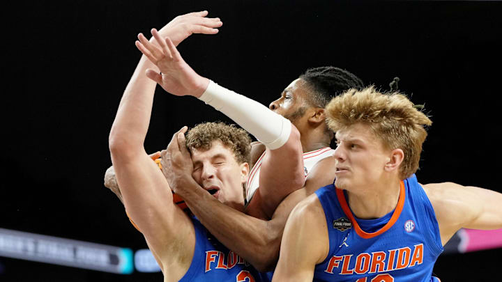 Florida Gators center Micah Handlogten and forward Thomas Haugh battle for the ball against Houston Cougars forward Joseph Tugler during the second half of the national championship game of the 2025 NCAA Tournament at the Alamodome. 