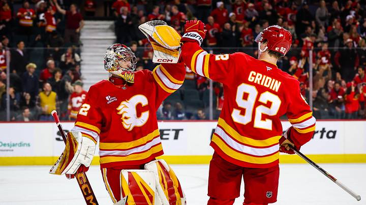 Mar 24, 2026; Calgary, Alberta, CAN; Calgary Flames goaltender Dustin Wolf (32) celebrates win with right wing Matvei Gridin (92) after defeating Los Angeles Kings during the shootout period at Scotiabank Saddledome. Mandatory Credit: Sergei Belski-Imagn Images
