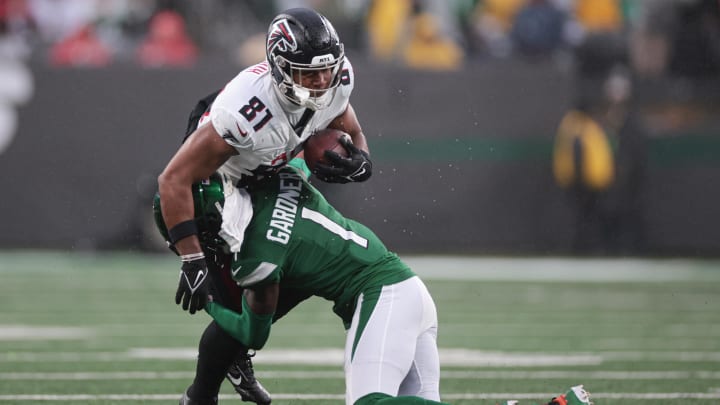 Dec 3, 2023; East Rutherford, New Jersey, USA; Atlanta Falcons tight end Jonnu Smith (81) is tackled by New York Jets cornerback Sauce Gardner (1) during the first half at MetLife Stadium. 