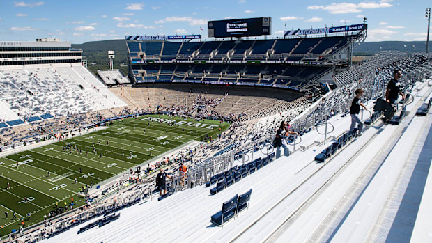 Fans walk up a section of temporary bleachers on the west side of Penn State's Beaver Stadium before a game vs. Nevada. 