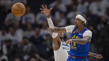 May 10, 2024; Minneapolis, Minnesota, USA; Denver Nuggets guard Kentavious Caldwell-Pope (5) passes the ball against the Minnesota Timberwolves in the second half during game three of the second round for the 2024 NBA playoffs at Target Center. Mandatory Credit: Jesse Johnson-USA TODAY Sports