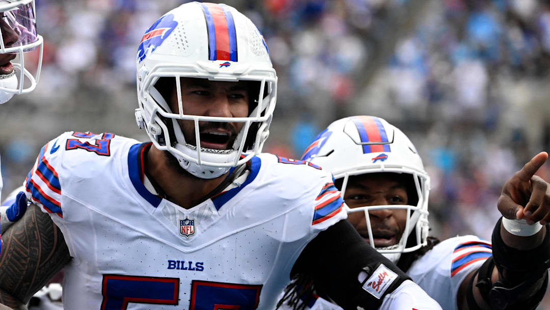 Oct 26, 2025; Charlotte, North Carolina, USA;  Buffalo Bills defensive end AJ Epenesa (57) celebrates with guard Connor McGovern (66) and linebacker Dorian Williams (42)  after intercepting a pass in the second quarter against the Carolina Panthers at Bank of America Stadium.