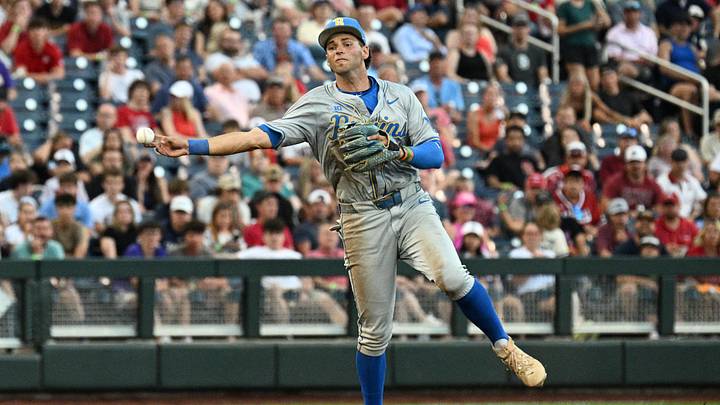 Jun 17, 2025; Omaha, Neb, USA;  UCLA Bruins shortstop Roch Cholowsky (1) throws to first base against the Arkansas Razorbacks during the third inning at Charles Schwab Field. Mandatory Credit: Steven Branscombe-Imagn Images