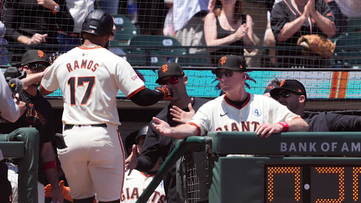 Jun 2, 2024; San Francisco, California, USA; San Francisco Giants left fielder Heliot Ramos (17) is congratulated by manager Bob Melvin (right) after hitting a home run against the New York Yankees during the third inning at Oracle Park.