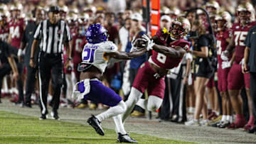 Nov 18, 2023; Tallahassee, Florida, USA; Florida State Seminoles tight end Jaheim Bell (6) catches the ball under pressure from North Alabama Lions linebacker Ashaad Williams (21) during the third quarter at Doak S. Campbell Stadium. Mandatory Credit: Morgan Tencza-Imagn Images
