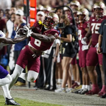 Nov 18, 2023; Tallahassee, Florida, USA; Florida State Seminoles tight end Jaheim Bell (6) catches the ball under pressure from North Alabama Lions linebacker Ashaad Williams (21) during the third quarter at Doak S. Campbell Stadium. Mandatory Credit: Morgan Tencza-Imagn Images