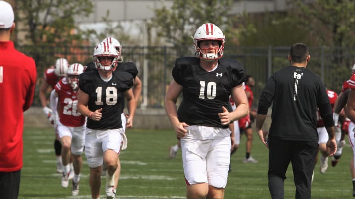 Wisconsin quarterbacks Tyler Van Dyke (10) and Braedyn Locke (18) warm up on the field north of Camp Randall Stadium in Madison, Wisconsin on Saturday April 27, 2024 before the team's intrasquad scrimmage.