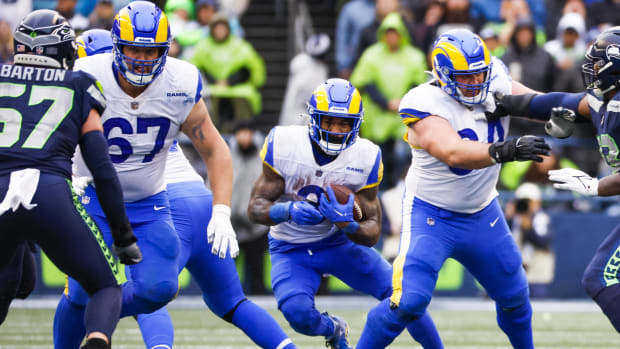 Los Angeles Rams running back Cam Akers (3) runs behind blocks from offensive lineman Chandler Brewer (67) 