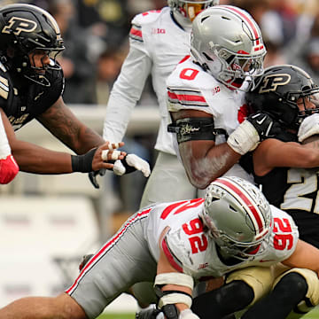Ohio State Buckeyes linebacker Sonny Styles (0) and Ohio State Buckeyes defensive end Caden Curry (92) tackle Purdue Boilermakers running back Antonio Harris (22) during the NCAA football game at Ross-Ade Stadium in West Lafayette, Ind. on Nov. 8, 2025. Ohio State won 34-10.