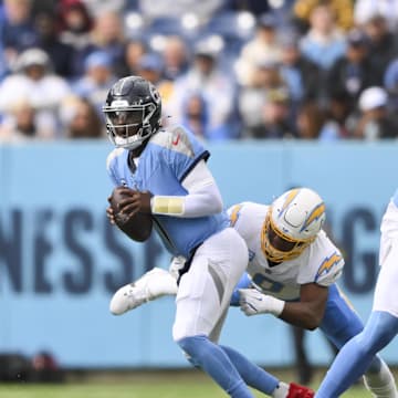 Nov 2, 2025; Nashville, Tennessee, USA; Los Angeles Chargers linebacker Daiyan Henley (0) sacks Tennessee Titans quarterback Cam Ward (1) during the second quarter at Nissan Stadium. Mandatory Credit: Steve Roberts-Imagn Images