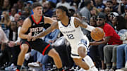 Nov 5, 2025; Memphis, Tennessee, USA; Memphis Grizzlies guard Ja Morant (12) dribbles as Houston Rockets guard Reed Sheppard (15) defends during the fourth quarter at FedExForum. Mandatory Credit: Petre Thomas-Imagn Images
