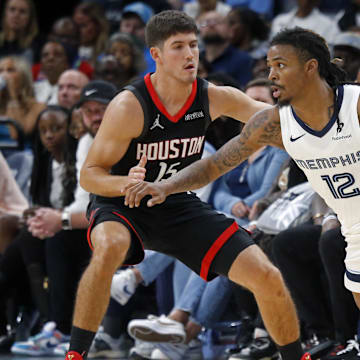 Nov 5, 2025; Memphis, Tennessee, USA; Memphis Grizzlies guard Ja Morant (12) dribbles as Houston Rockets guard Reed Sheppard (15) defends during the fourth quarter at FedExForum. Mandatory Credit: Petre Thomas-Imagn Images