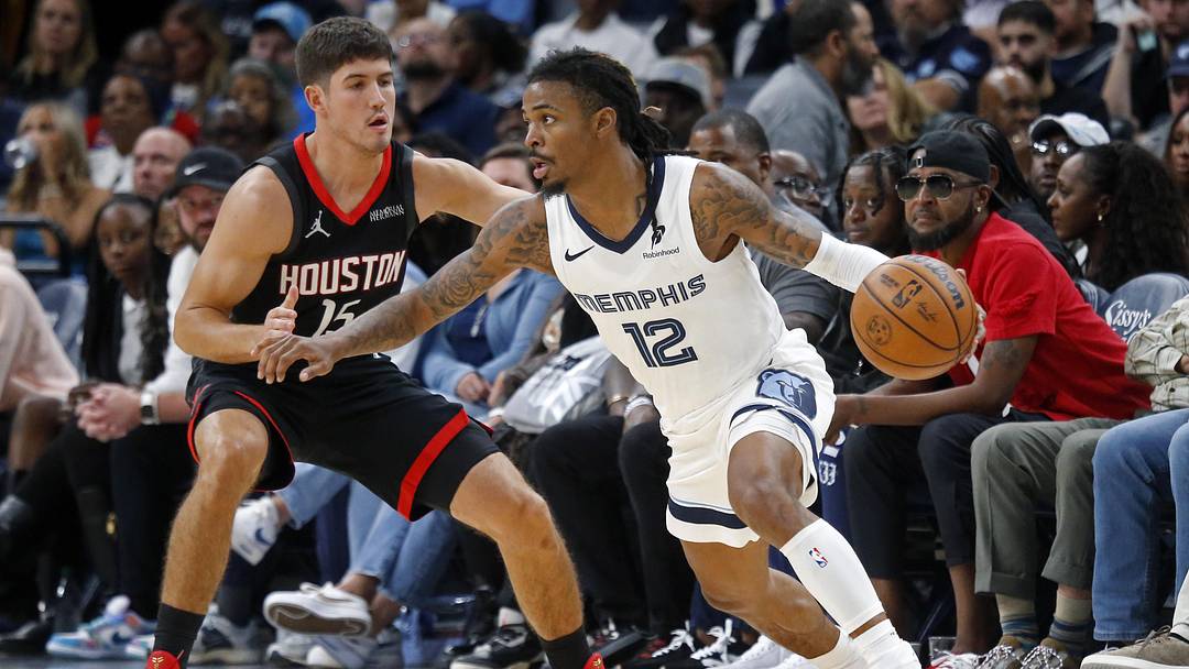 Nov 5, 2025; Memphis, Tennessee, USA; Memphis Grizzlies guard Ja Morant (12) dribbles as Houston Rockets guard Reed Sheppard (15) defends during the fourth quarter at FedExForum. Mandatory Credit: Petre Thomas-Imagn Images