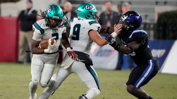 Gulf Shores' Ronnie Royal (2) follows a block by Gulf Shores' Rosser Stephens (9) on Ramsay   s Marquel Patterson (25)