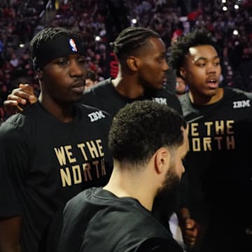 Dec 18, 2022; Toronto, Ontario, CAN; Toronto Raptors forward Chris Boucher (left) and forward Christian Koloko (35) and forward Scottie Barnes (4) and forward Thaddeus Young (right) surround guard Fred VanVleet (23)  during the player introductions before a game against the Golden State Warriors during the second half at Scotiabank Arena. Mandatory Credit: John E. Sokolowski-Imagn Images