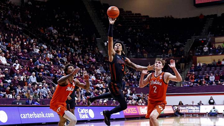 Jan 4, 2025; Blacksburg, Virginia, USA; Miami Hurricanes guard Jalil Bethea (3) shoots the ball against Virginia Tech Hokies guard Jaden Schutt (2) and forward Tobi Lawal (1) during the second half at Cassell Coliseum. Mandatory Credit: Peter Casey-Imagn Images