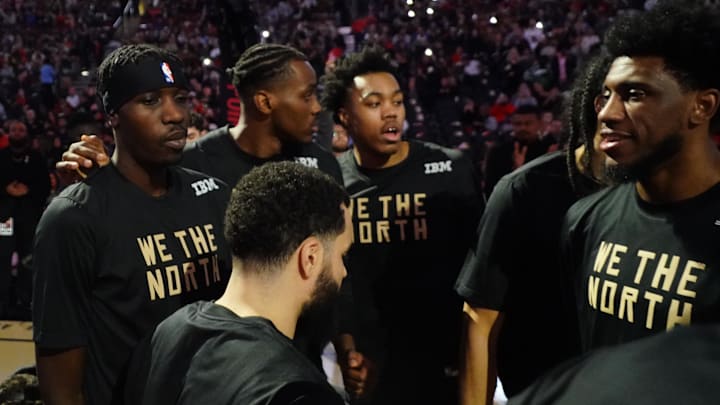 Dec 18, 2022; Toronto, Ontario, CAN; Toronto Raptors forward Chris Boucher (left) and forward Christian Koloko (35) and forward Scottie Barnes (4) and forward Thaddeus Young (right) surround guard Fred VanVleet (23)  during the player introductions before a game against the Golden State Warriors during the second half at Scotiabank Arena. Mandatory Credit: John E. Sokolowski-Imagn Images