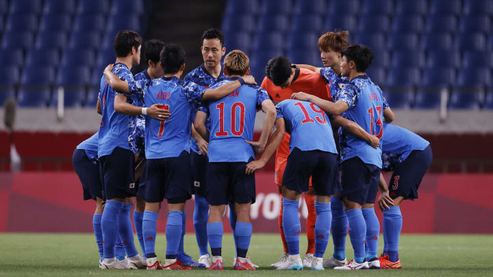 Japan players huddle before playing Spain  in a men's soccer semifinal match during the Tokyo 2020 Olympic Summer Games at Saitama Stadium.