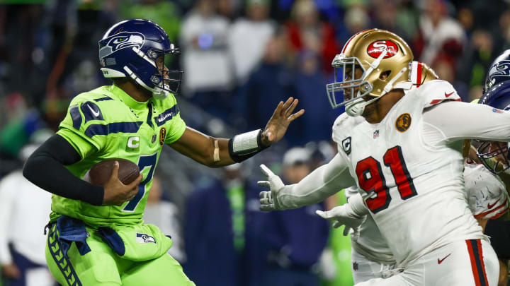 Nov 23, 2023; Seattle, Washington, USA; San Francisco 49ers defensive end Arik Armstead (91) sacks Seattle Seahawks quarterback Geno Smith (7) during the fourth quarter at Lumen Field. Mandatory Credit: Joe Nicholson-USA TODAY Sports