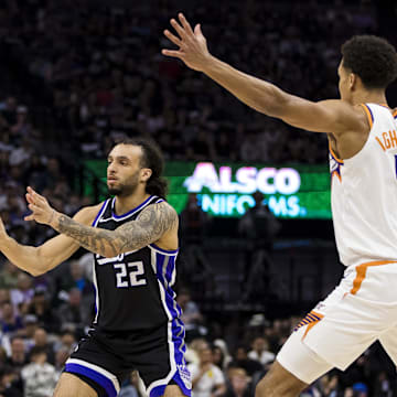 Apr 13, 2025; Sacramento, California, USA;  Sacramento Kings guard Devin Carter (22) passes against the Phoenix Suns during the first quarter at Golden 1 Center. Mandatory Credit: John Hefti-Imagn Images