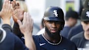 Chicago White Sox center fielder Luis Robert Jr. (88) high-fives teammates after scoring against the Seattle Mariners at T-Mobile Park.