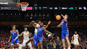 Florida Gators center Rueben Chinyelu (9) and Florida Gators forward Alex Condon (21) reach for a rebound against the Houston Cougars in the second half in the national championship game.
