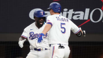 Texas Rangers shortstop Corey Seager (5) is congratulated by right fielder Adolis Garcia