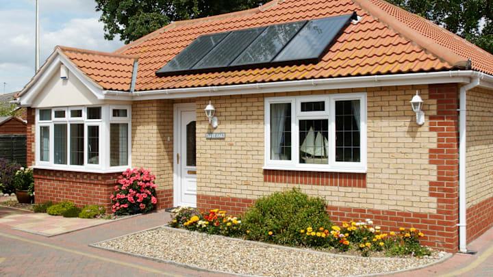 Solar heating panels on a bungalow roof, Clacton-on-Sea, Essex, UK