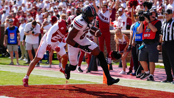 South Carolina Gamecocks tight end Joshua Simon (6) scores a touchdown in front of Oklahoma Sooners defensive back Billy Bowman Jr. (2) during a college football game between the University of Oklahoma Sooners (OU) and the South Carolina Gamecocks at Gaylord Family - Oklahoma Memorial Stadium in Norman, Okla., Saturday, Oct. 19, 2024.