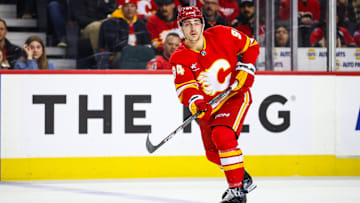 Dec 12, 2024; Calgary, Alberta, CAN; Calgary Flames defenseman Brayden Pachal (94) passes the puck against the Tampa Bay Lightning during the second period at Scotiabank Saddledome. Mandatory Credit: Sergei Belski-Imagn Images