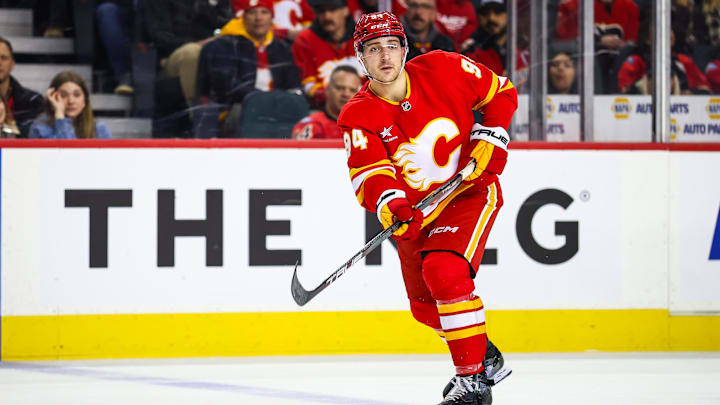 Dec 12, 2024; Calgary, Alberta, CAN; Calgary Flames defenseman Brayden Pachal (94) passes the puck against the Tampa Bay Lightning during the second period at Scotiabank Saddledome. Mandatory Credit: Sergei Belski-Imagn Images