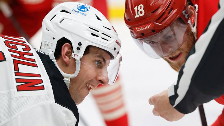 Apr 11, 2026; Detroit, Michigan, USA;  New Jersey Devils center Marc McLaughlin (21) gets set to face off with Detroit Red Wings center Andrew Copp (18) in the second period at Little Caesars Arena. Mandatory Credit: Rick Osentoski-Imagn Images