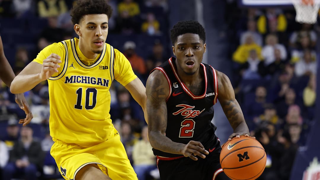 Dec 29, 2024; Ann Arbor, Michigan, USA;  Western Kentucky Hilltoppers guard Don McHenry (2) dribbles against Michigan Wolverines guard Justin Pippen (10) in the second half at Crisler Center. Mandatory Credit: Rick Osentoski-Imagn Images