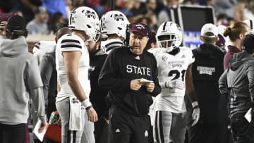 Nov 24, 2022; Oxford, Mississippi, USA; Mississippi State Bulldogs head coach Mike Leach speaks with quarterback Will Rogers (2) during the first quarter of the game against the Ole Miss Rebels at Vaught-Hemingway Stadium. Mandatory Credit: Matt Bush-USA TODAY Sports