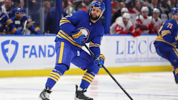 Dec 9, 2024; Buffalo, New York, USA;  Buffalo Sabres left wing Jordan Greenway (12) looks for the puck during the third period against the Detroit Red Wings at KeyBank Center. Mandatory Credit: Timothy T. Ludwig-Imagn Images