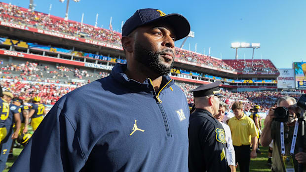 Michigan Wolverines head coach Sherrone Moore celebrates after beating the Alabama Crimson Tide in the ReliaQuest Bowl.