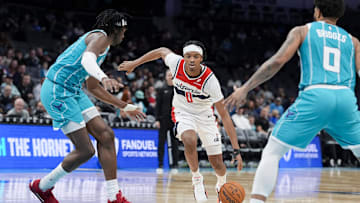 Feb 3, 2025; Charlotte, North Carolina, USA; Washington Wizards guard Bilal Coulibaly (0) drives to the basket against Charlotte Hornets center Mark Williams (5) during the second half at Spectrum Center. Mandatory Credit: Jim Dedmon-Imagn Images