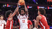 Nov 8, 2025; New York, New York, USA; St. John's Red Storm guard Ian Jackson (11) looks to drive past Alabama Crimson Tide guard Aden Holloway (2) and forward Amari Allen (5) in the second half at Madison Square Garden. Mandatory Credit: Wendell Cruz-Imagn Images