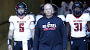 Nov 18, 2023; Blacksburg, Virginia, USA; North Carolina State Wolfpack head coach Dave Doeren walks to the field with his team before the game against the Virginia Tech Hokies at Lane Stadium. Mandatory Credit: Peter Casey-Imagn Images
