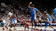 Jan 14, 2025; Tuscaloosa, AL, USA; Alabama guard Mark Sears (1) slips to the floor as he tries to get into the lane and is defended by Ole Miss forward Jaemyn Brakefield (4) at Coleman Coliseum. Ole Miss defeated Alabama 74-64. Mandatory Credit: Gary Cosby Jr.-Tuscaloosa News