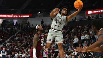 Feb 18, 2025; Starkville, Mississippi, USA; Mississippi State Bulldogs guard Josh Hubbard (12) shoots against Texas A&M Aggies guard Manny Obaseki (35) during the second half at Humphrey Coliseum. Mandatory Credit: Petre Thomas-Imagn Images