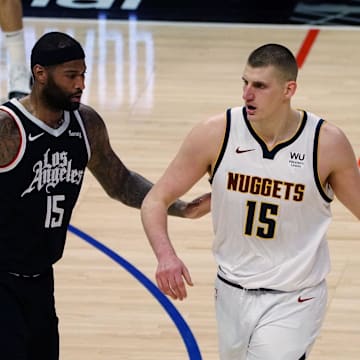May 1, 2021; Los Angeles, California, USA; Denver Nuggets center Nikola Jokic (15) moves the ball against Los Angeles Clippers center DeMarcus Cousins (15) during the second half at Staples Center. Mandatory Credit: Gary A. Vasquez-Imagn Images